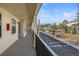 Exterior hallway with views of the parking lot and landscaping at 460 Paula S Dr # 401, Dunedin, FL 34698