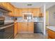 Kitchen with wood cabinets, granite countertops, and stainless steel appliances at 460 Paula S Dr # 401, Dunedin, FL 34698