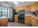 Kitchen features wood cabinets, granite counters, and stainless steel appliances at 460 Paula S Dr # 401, Dunedin, FL 34698