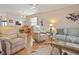 Living room with ample seating and wood floors at 460 Paula S Dr # 401, Dunedin, FL 34698