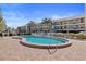 Community pool with surrounding patio at 460 Paula S Dr # 401, Dunedin, FL 34698