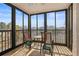 Relaxing screened porch with table and chairs, offering views of the neighborhood at 460 Paula S Dr # 401, Dunedin, FL 34698