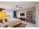 Bright bedroom with large window, king bed, and ceiling fan at 4900 Brittany S Dr # 909, St Petersburg, FL 33715