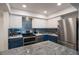 Modern kitchen with stainless steel appliances and blue cabinets at 4900 Brittany S Dr # 909, St Petersburg, FL 33715