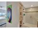 Modern bathroom featuring a glass enclosed shower and a flamingo artwork hanging outside of it at 5155 S Isla Key S Blvd # 202, St Petersburg, FL 33715