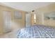 Cozy bedroom with a large patterned comforter and a view of the kitchen entryway at 5155 S Isla Key S Blvd # 202, St Petersburg, FL 33715