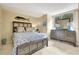 Comfortable bedroom with a decorative fish wall hanging, dresser, and a sun-filled window at 5155 S Isla Key S Blvd # 202, St Petersburg, FL 33715