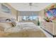 Primary bedroom with water view and large bed at 5155 S Isla Key S Blvd # 202, St Petersburg, FL 33715