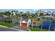 Aerial view of gated community entrance with lush landscaping, water feature, and access to waterfront condos at 5155 S Isla Key S Blvd # 202, St Petersburg, FL 33715