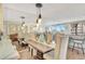Dining room featuring a large mirror, stylish lighting, seating for six, and water views at 5155 S Isla Key S Blvd # 202, St Petersburg, FL 33715