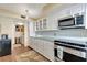Bright kitchen features white cabinets, stainless steel appliances, and a unique aqua-colored countertop at 5155 S Isla Key S Blvd # 202, St Petersburg, FL 33715