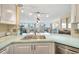 Updated kitchen with white cabinets, stainless steel appliances, and a light counter at 5155 S Isla Key S Blvd # 202, St Petersburg, FL 33715
