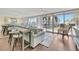 Open living area with stylish seating, bar area, wood floors, and stunning water views at 5155 S Isla Key S Blvd # 202, St Petersburg, FL 33715