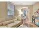 Living area with beige couch and view into the kitchen at 5155 S Isla Key S Blvd # 202, St Petersburg, FL 33715