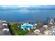 Aerial view of a community pool area with ocean views and lush landscaping at 5155 S Isla Key S Blvd # 202, St Petersburg, FL 33715