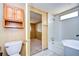 Small bathroom with a toilet and built-in cabinet at 6021 Ridgewood Dr, Zephyrhills, FL 33542