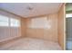 Simple bedroom with wood paneling and neutral carpet at 6021 Ridgewood Dr, Zephyrhills, FL 33542