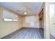 Bedroom with ceiling fan and wood-paneled walls at 6021 Ridgewood Dr, Zephyrhills, FL 33542
