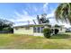 Yellow single story home with landscaped yard at 6021 Ridgewood Dr, Zephyrhills, FL 33542