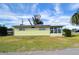Yellow single story home with green lawn at 6021 Ridgewood Dr, Zephyrhills, FL 33542