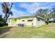 Another side view of yellow single story home at 6021 Ridgewood Dr, Zephyrhills, FL 33542