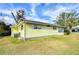 Side view of a yellow single story home at 6021 Ridgewood Dr, Zephyrhills, FL 33542