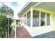 Ranch-style home with yellow siding and wood ramp at 6021 Ridgewood Dr, Zephyrhills, FL 33542