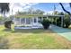 Yellow single-story home with carport and landscaped lawn at 6021 Ridgewood Dr, Zephyrhills, FL 33542