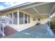 Side view of a yellow single-story home with ramp access at 6021 Ridgewood Dr, Zephyrhills, FL 33542