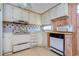 White kitchen cabinets, wood paneling, and appliances at 6021 Ridgewood Dr, Zephyrhills, FL 33542