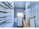 Laundry room with washer, dryer, and shelving at 6021 Ridgewood Dr, Zephyrhills, FL 33542