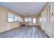 Bright living room featuring wood paneling and vinyl flooring at 6021 Ridgewood Dr, Zephyrhills, FL 33542