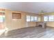 Living room with large windows and vinyl flooring at 6021 Ridgewood Dr, Zephyrhills, FL 33542