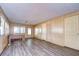 Spacious living room with wood-paneled walls and vinyl flooring at 6021 Ridgewood Dr, Zephyrhills, FL 33542