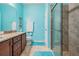 Bright bathroom features a glass enclosed shower with tiled surround, granite countertop, and tile flooring at 714 Sugar Camp Way, Brooksville, FL 34604