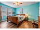 Spacious bedroom has hardwood floors, natural light, and warm colored accents at 714 Sugar Camp Way, Brooksville, FL 34604