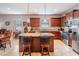 Modern kitchen with a granite island, stainless steel appliances, and tiled floors, ideal for entertaining at 714 Sugar Camp Way, Brooksville, FL 34604
