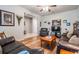 Cozy living room with wood flooring, leather seating, and abundant natural light creates a warm atmosphere at 714 Sugar Camp Way, Brooksville, FL 34604