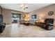 Cozy living room with tile floors and sliding doors to a screened in patio at 714 Sugar Camp Way, Brooksville, FL 34604