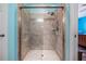 Shower with updated tiling, shower head and glass door at 714 Sugar Camp Way, Brooksville, FL 34604