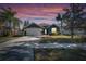 Gray house with white garage door, landscaping, at dusk at 10322 Goldenbrook Way, Tampa, FL 33647