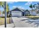 Gray house with white garage door and driveway at 10322 Goldenbrook Way, Tampa, FL 33647