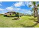 Landscaped backyard with screened patio at 11111 Callisia Dr, Odessa, FL 33556