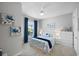 Cozy bedroom with a queen bed, dresser, and coastal decor at 11111 Callisia Dr, Odessa, FL 33556