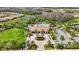 Community clubhouse with pool, palm trees, and parking area at 11111 Callisia Dr, Odessa, FL 33556