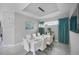 Modern dining room, light walls, large art piece, and clock at 11111 Callisia Dr, Odessa, FL 33556