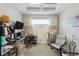 Spacious home office with a desk, two chairs, and large window at 11111 Callisia Dr, Odessa, FL 33556