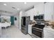 Modern kitchen, stainless steel appliances, white cabinets, and breakfast nook at 11111 Callisia Dr, Odessa, FL 33556