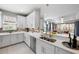 Modern kitchen with white cabinets, stainless steel appliances, and an island at 11111 Callisia Dr, Odessa, FL 33556