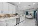 Modern kitchen with white cabinets, stainless steel appliances, and an island at 11111 Callisia Dr, Odessa, FL 33556
